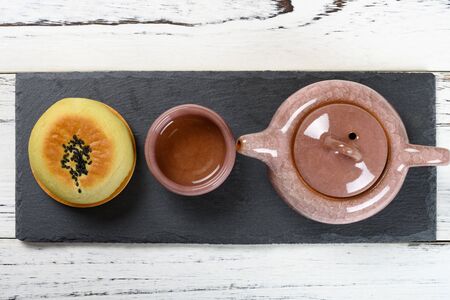 top view red bean paste cake  and cup of tea with teapot