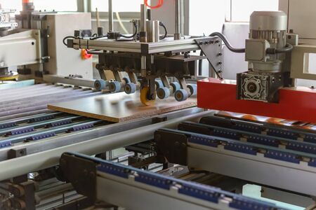 machine handling plywood in a factory