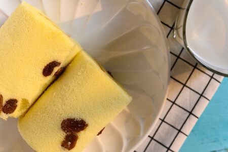 top view cakes with raisin and cup of milk close up in a sunny morning