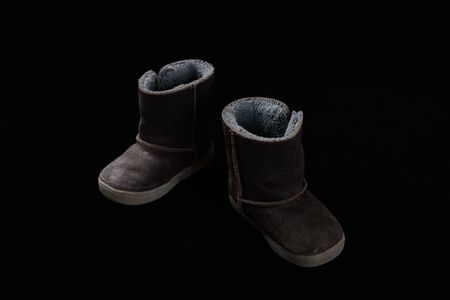 Winter boots for kid on black background