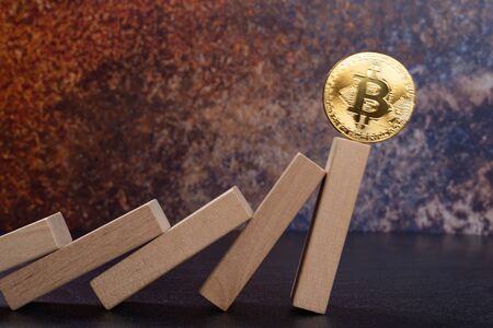 bitcoin falling down from domino blocksの写真素材