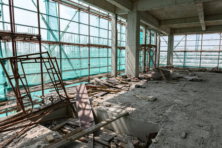 inside of an unfinished building with protection scaffolding and netting surroundedのeditorial素材