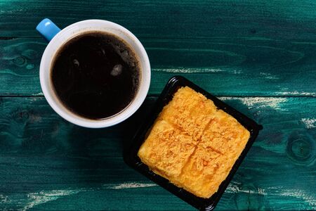 top view shredded pork cake and cup of coffee
