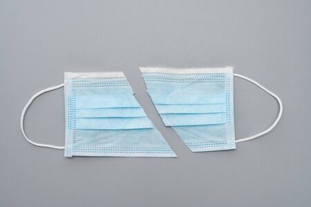Medical mask cut in half on grey backgroundの写真素材