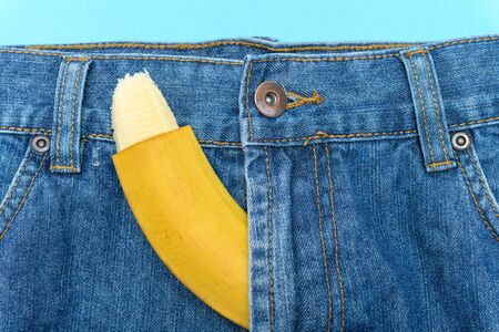 banana sticks out of mens jeans like mens penis as potency conceptの写真素材