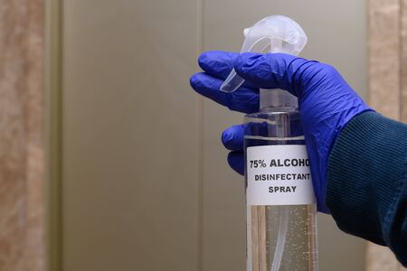 75 percent alcohol disinfectant spray in front of a liftの写真素材