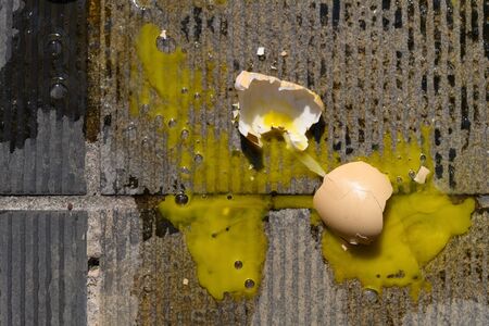 top view broken egg on a concrete floor