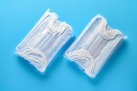 packs of  medical face masks for children on a blue background