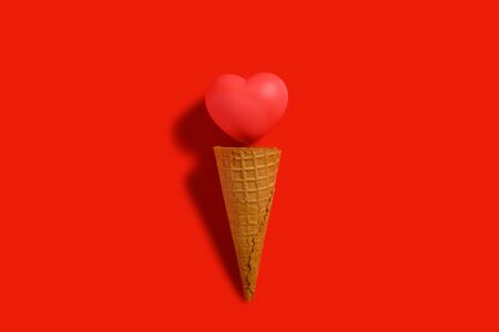 ice cream cone with a heart on red background concept of healthy eatingの写真素材