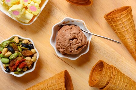 top view chocolate flavor ice cream with marshmallows and various nuts