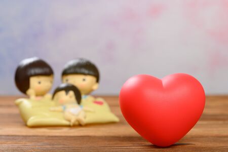 a red heart and parents and the son on backgroundの写真素材