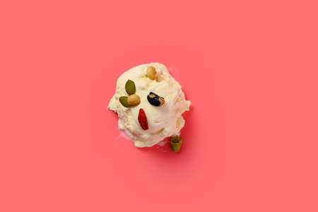top of a fresh hami melon and oats flavor ice cream cone with couple of bites on green background