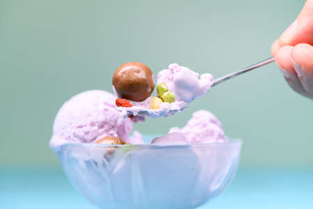 vanilla flavor ice cream cone melting on blue background