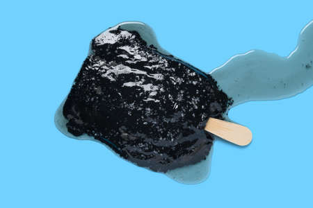 top view chocolate flavor ice cream stick shredded coconut melted on blue background