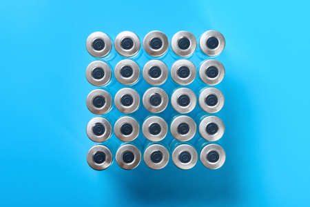top view empty vaccine bottles on blue background