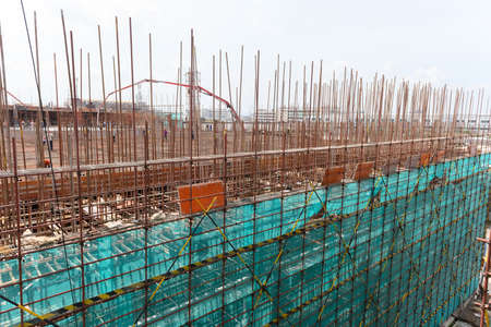 outside of an unfinished building with protection scaffolding and netting surrounded