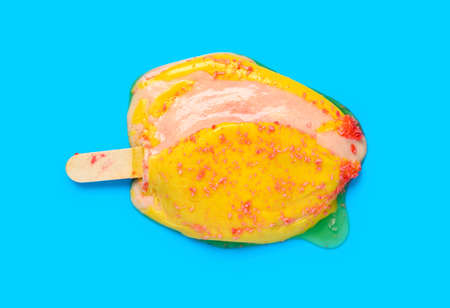 top view cheese flavor ice cream stick melting on a blue backgroundの写真素材