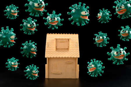 house surrounded by lots of coronavirus in dark space