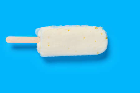 top view fresh mango and condensed milk flavor ice cream stick on blue background