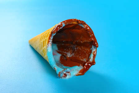 angle view empty ice cream cone on a blue background