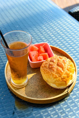 cup of fresh cold drink and piece of bread and some watermelonの写真素材