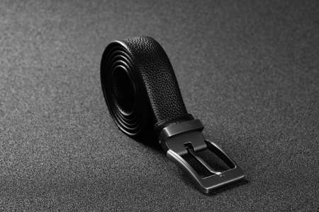 steel hook of elegant leather belt for men on a dark background horizontal composition