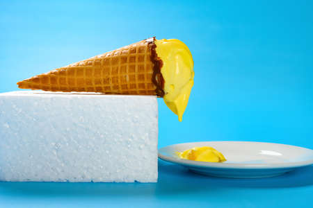 melting durian flavor ice cream cone and dropping to a dishの写真素材