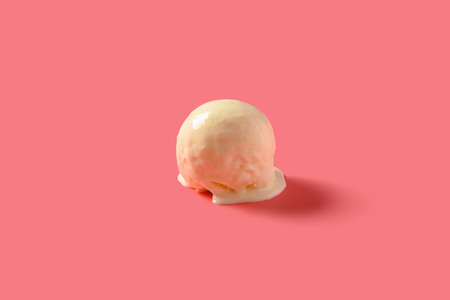 side view vanilla flavor ice cream ball starts melting on pink background