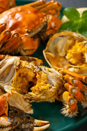 angle view crabs with one opened showing the crab roe and meat vertical compositionの写真素材