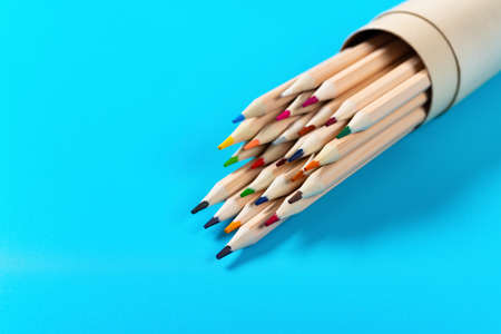 set of color pencils on a blue background