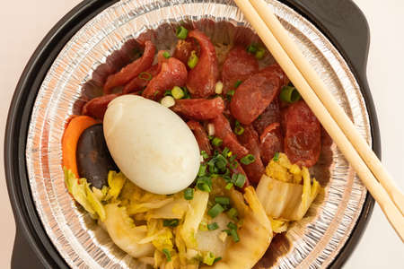 top view clay pot rice of Chinese style sausage and salty duck egg and vegetable horizontal...
