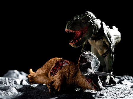 tyrannosaurus with a triceratops body on a ground with craters