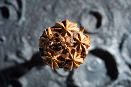 chocolate flavor ice cream on a rough surface with cratersの写真素材