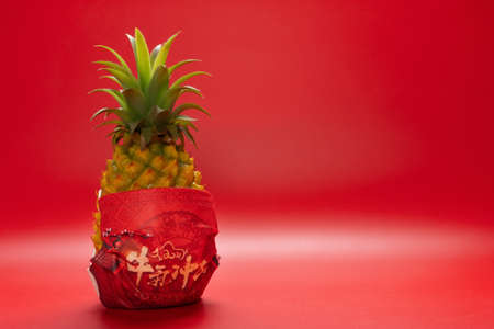 pineapple wears a medical mask printed with Chinese characters means bullish year of Oxの写真素材