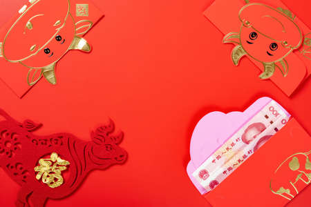 red pockets with Chinese currency for the year Ox and the Chinese means luck and fortuneの写真素材