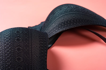 angle view of a black bra for women on a pink backgroundの写真素材