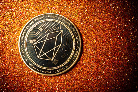 EOS coin on a dark background close up