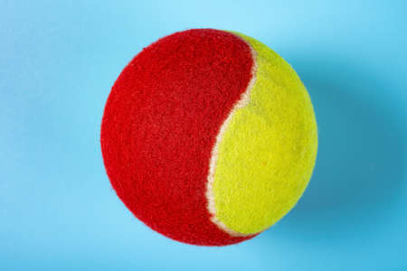 tennis ball on a blue background close up