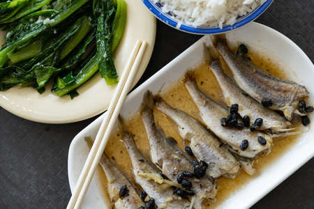 top view fast food of small fishes with vegetable and rice horizontal composition