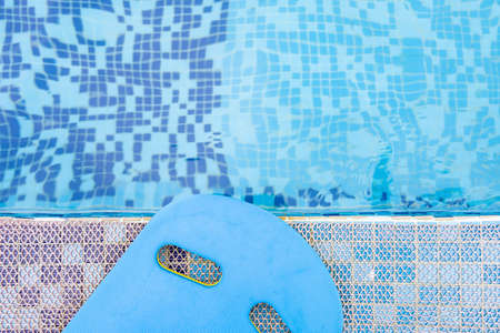 top view blue floating pad near a swimming pool horizontal compositionの写真素材