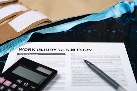 work injury claim form with CT film medical and insurance conceptの写真素材