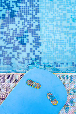 top view blue floating pad near a swimming pool vertical compositionのeditorial素材