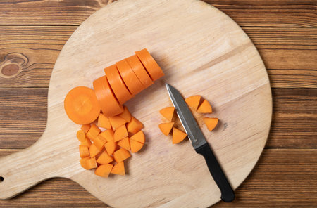 cutting fresh carrot on a chop boardの写真素材