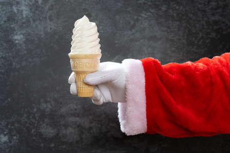 santa claus holds an ice cream coneの写真素材