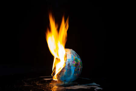 a burning globe on dark backgroundの写真素材
