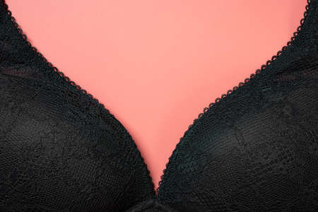 black bra for women close up on the central v shape on pink backgroundの写真素材