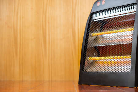 electric heater on a wooden floorの写真素材