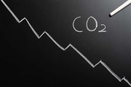 decreasing lines on a blackboard showing CO2 reducing trendの写真素材
