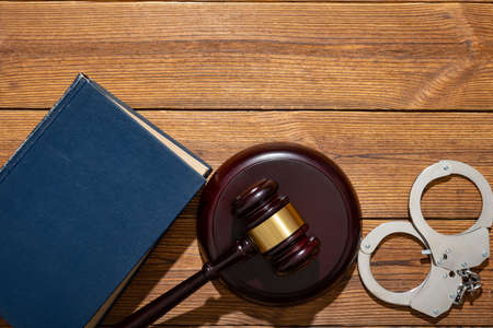 top view gavel and handcuffs with a bookの写真素材