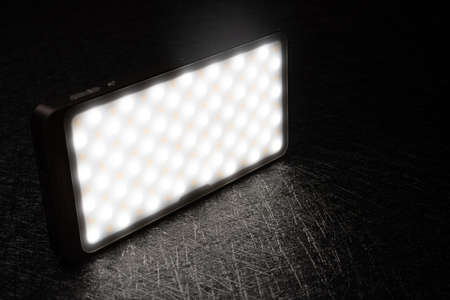 mini portable photography LED light on a dark backgroundの写真素材